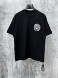 Black short-sleeve T-shirt with small circular chrome-style chest graphic