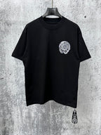 Black short-sleeve T-shirt with small circular chrome-style chest graphic