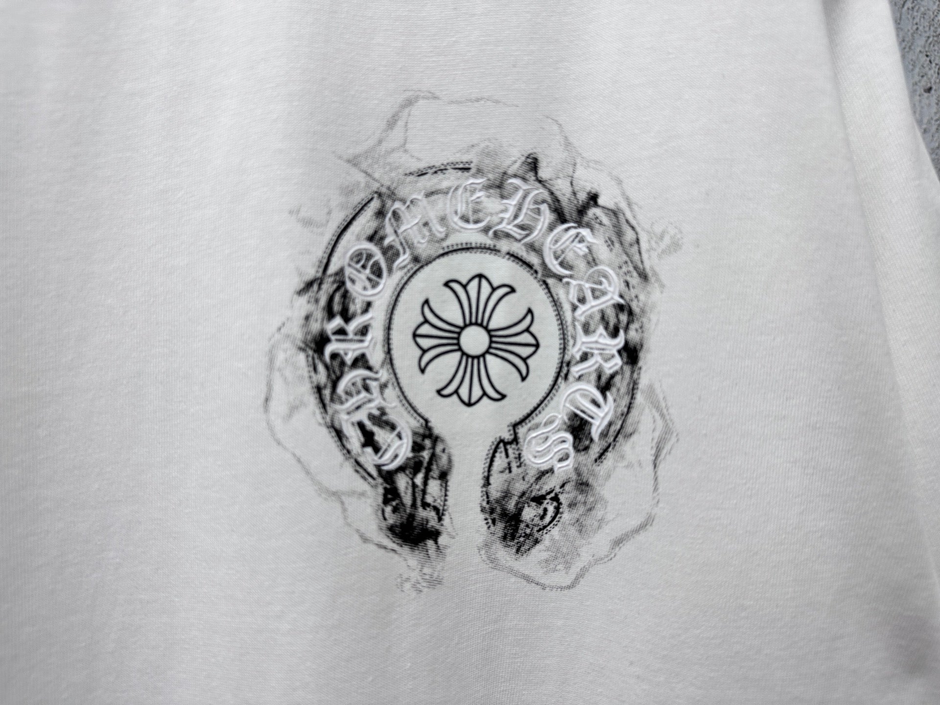 White T-shirt with detailed circular emblem graphic