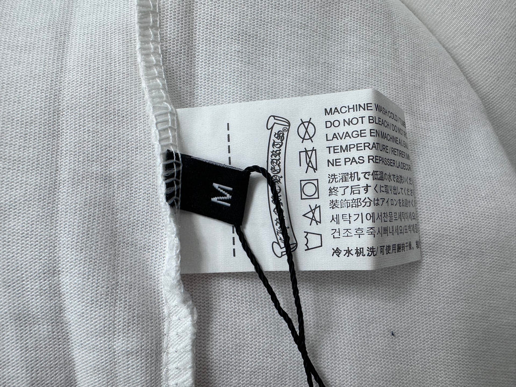 White T-shirt care label with icons and washing instructions