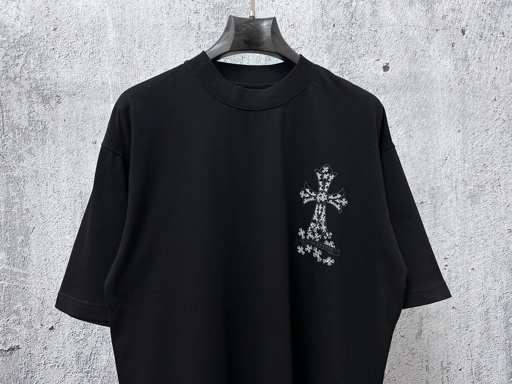 Black short-sleeve crewneck T-shirt with small white cross graphic on right chest