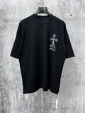 Black short-sleeve crewneck T-shirt with small white cross graphic on chest