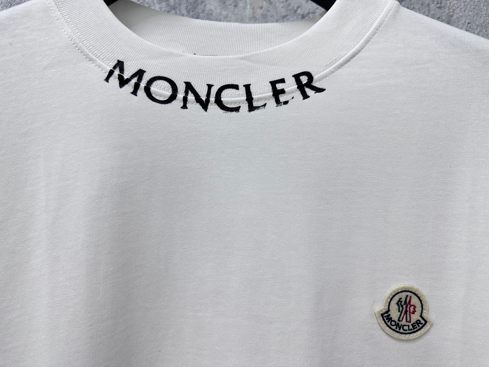White Moncler T-shirt neckline with MONCLER text across collar