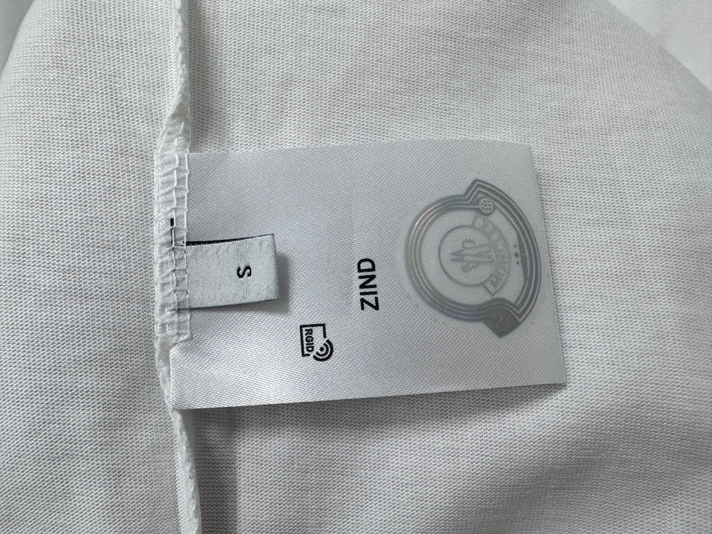 White Moncler T-shirt fabric label and size tag on seam