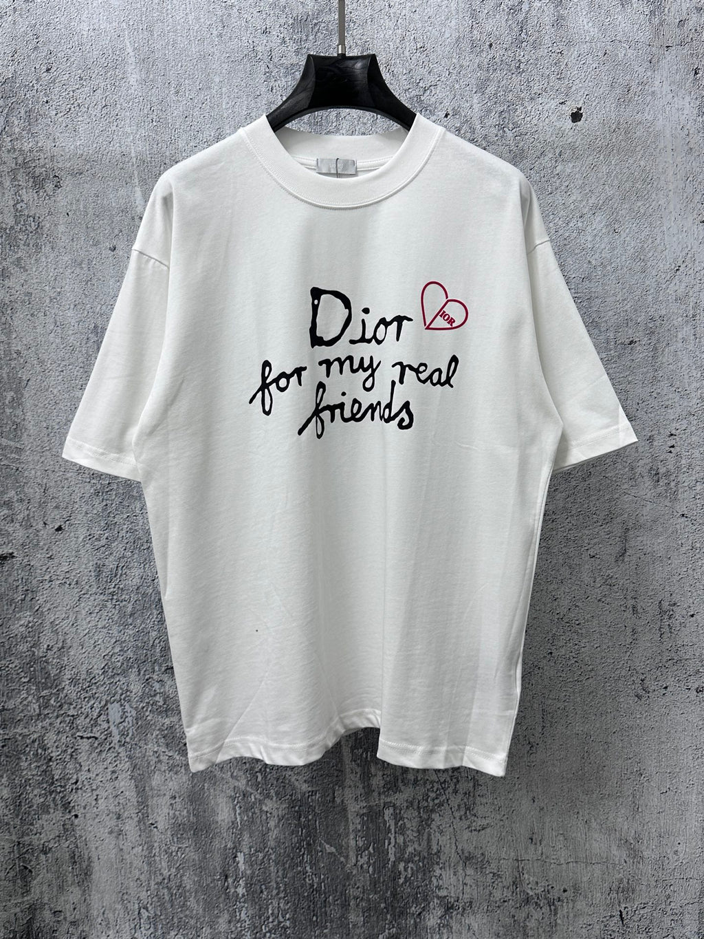 White crewneck T-shirt with black and red Dior-style graphic on front