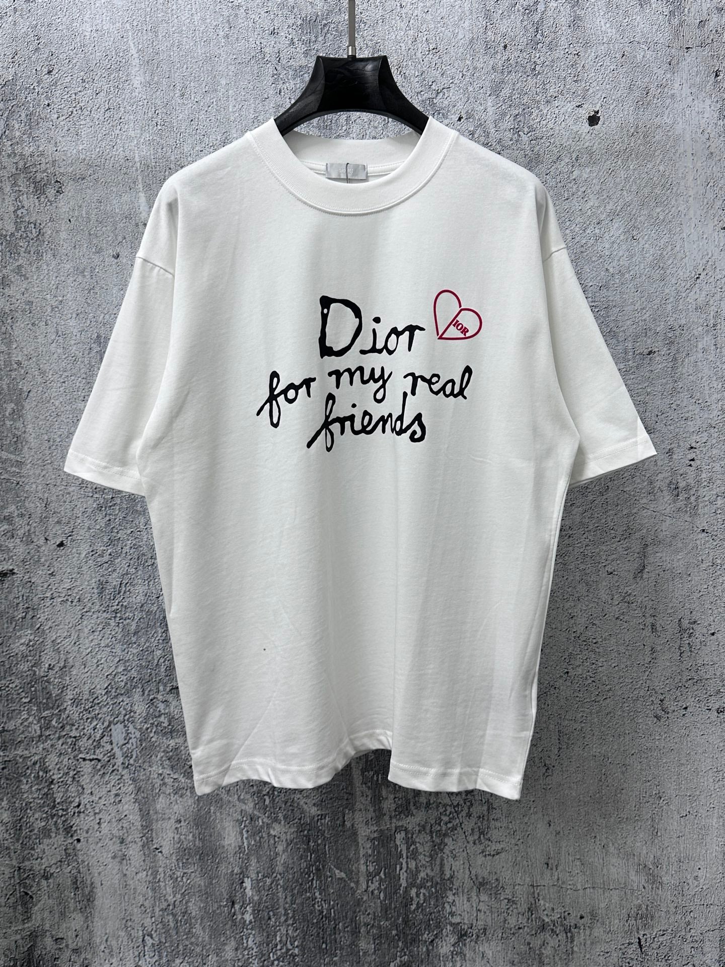 White crewneck T-shirt with black and red Dior-style graphic on front