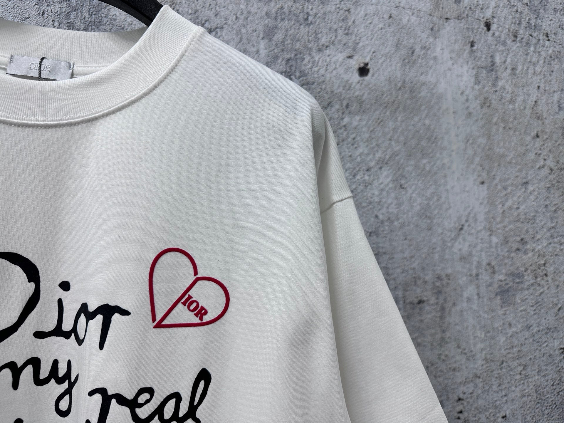 White T-shirt detail: Dior for my real friends graphic with red heart
