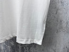 White T-shirt hem and side seam detail under short sleeves