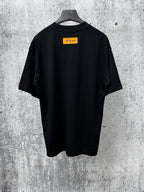 Back view short-sleeve black T-shirt with orange rectangular logo label