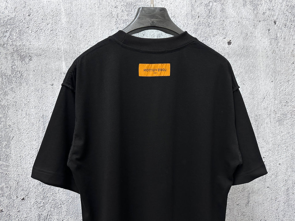 Back view short-sleeve black T-shirt with orange logo label near collar