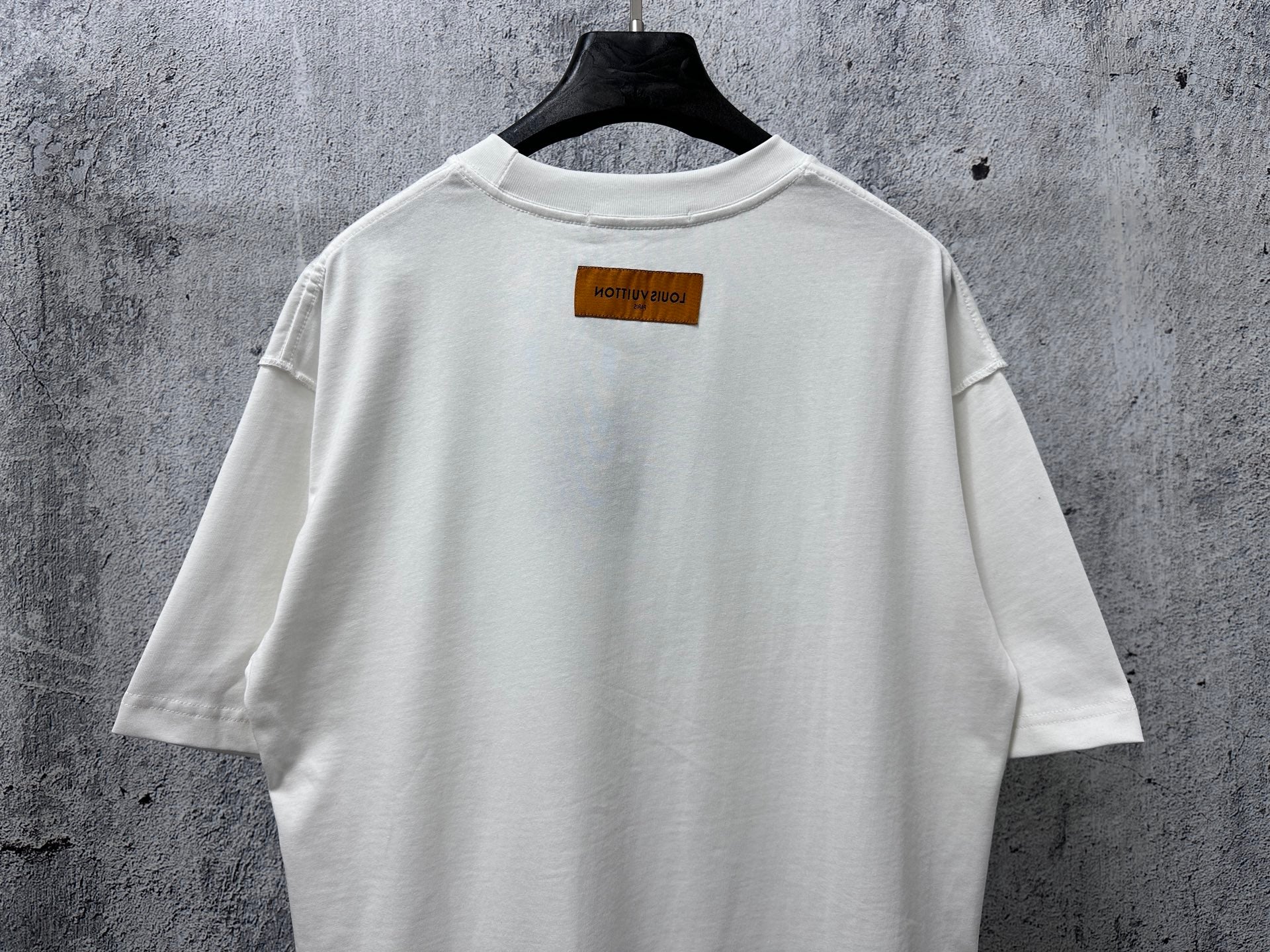 White T-shirt back with small rectangular label near the collar
