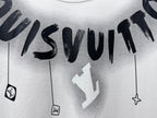 White T-shirt close-up with black “Louisvuitton” text and hanging charm icons