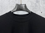 Balenciaga black crew neck T-shirt, close-up of neckline and upper chest