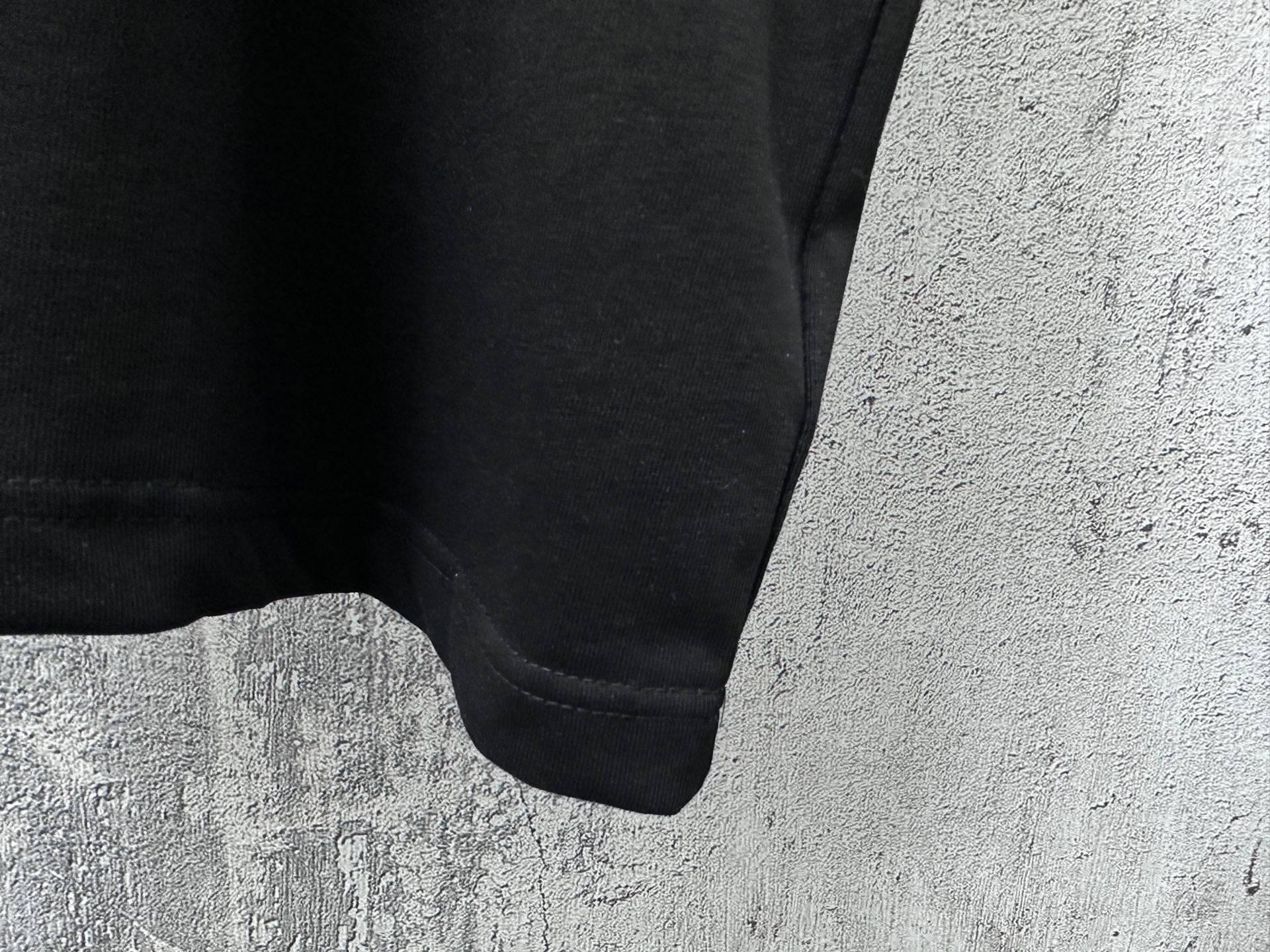 Balenciaga short-sleeve T-shirt, close-up of lower hem and sleeve cuff