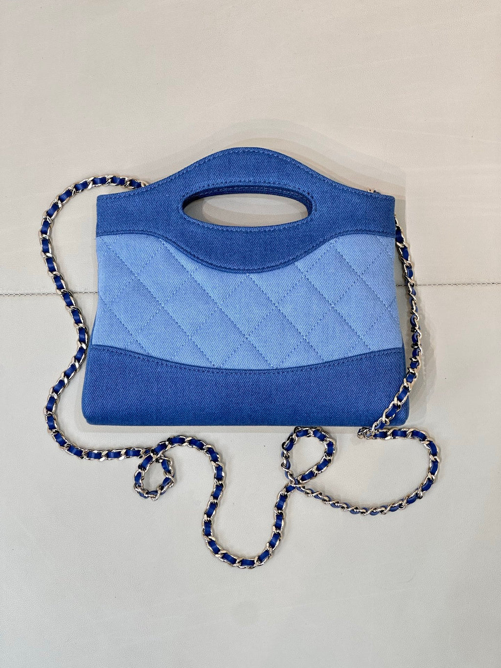 Chanel blue quilted mini bag with top handle cutout and braided chain shoulder strap