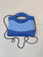 Chanel blue quilted mini bag with top handle cutout and braided chain shoulder strap