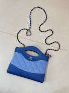 Chanel mini blue quilted bag with oval handle cutout and chain shoulder strap