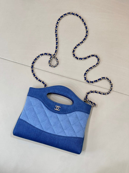 Chanel mini blue quilted bag with oval handle cutout and chain shoulder strap