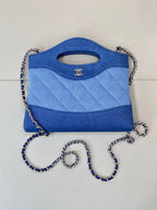 Chanel blue quilted bag with top handle cutout and silver-tone chain strap