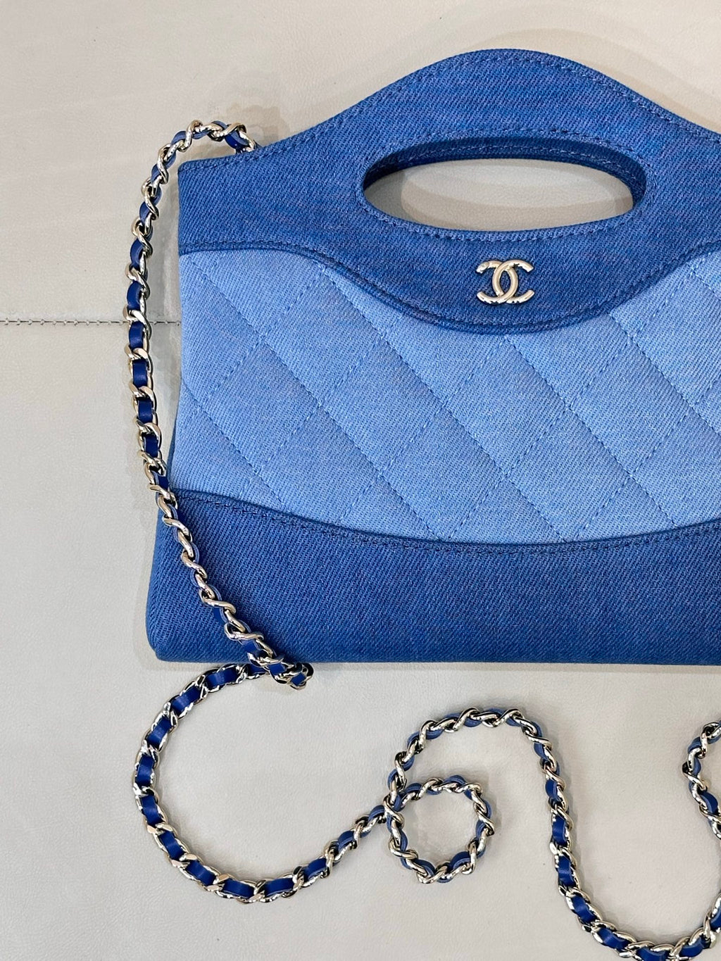 Chanel blue quilted bag with side seam details and silver-tone chain shoulder strap