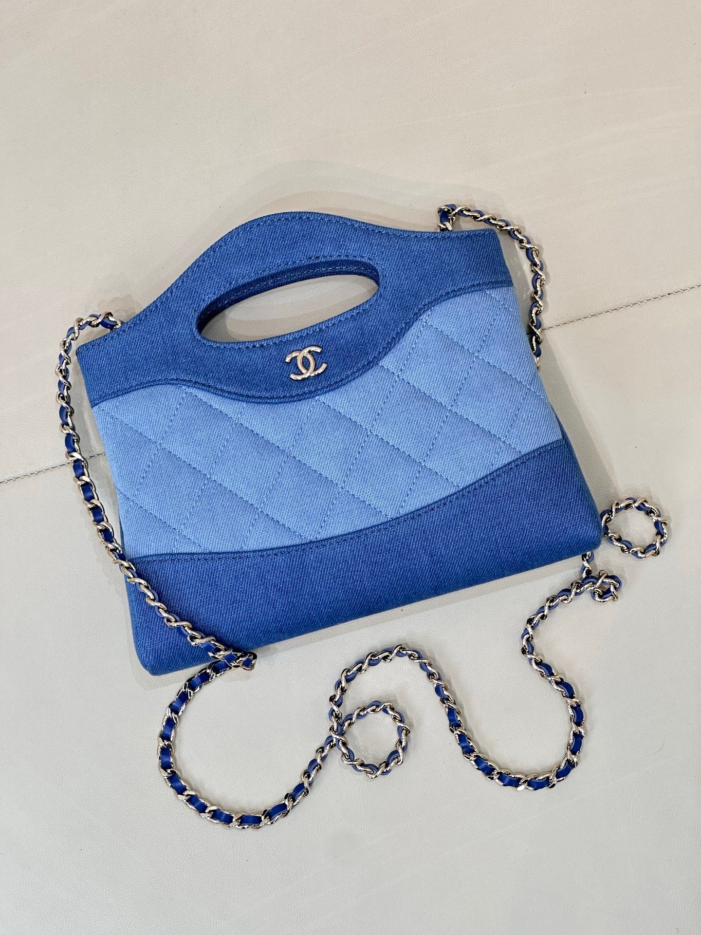 Chanel blue mini quilted bag with top handle cutout and chain strap