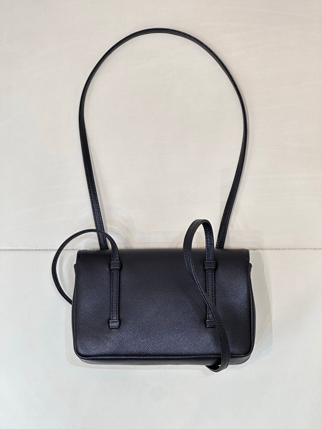 Chanel handbag front view with flap, dark blue leather, and two top handles.