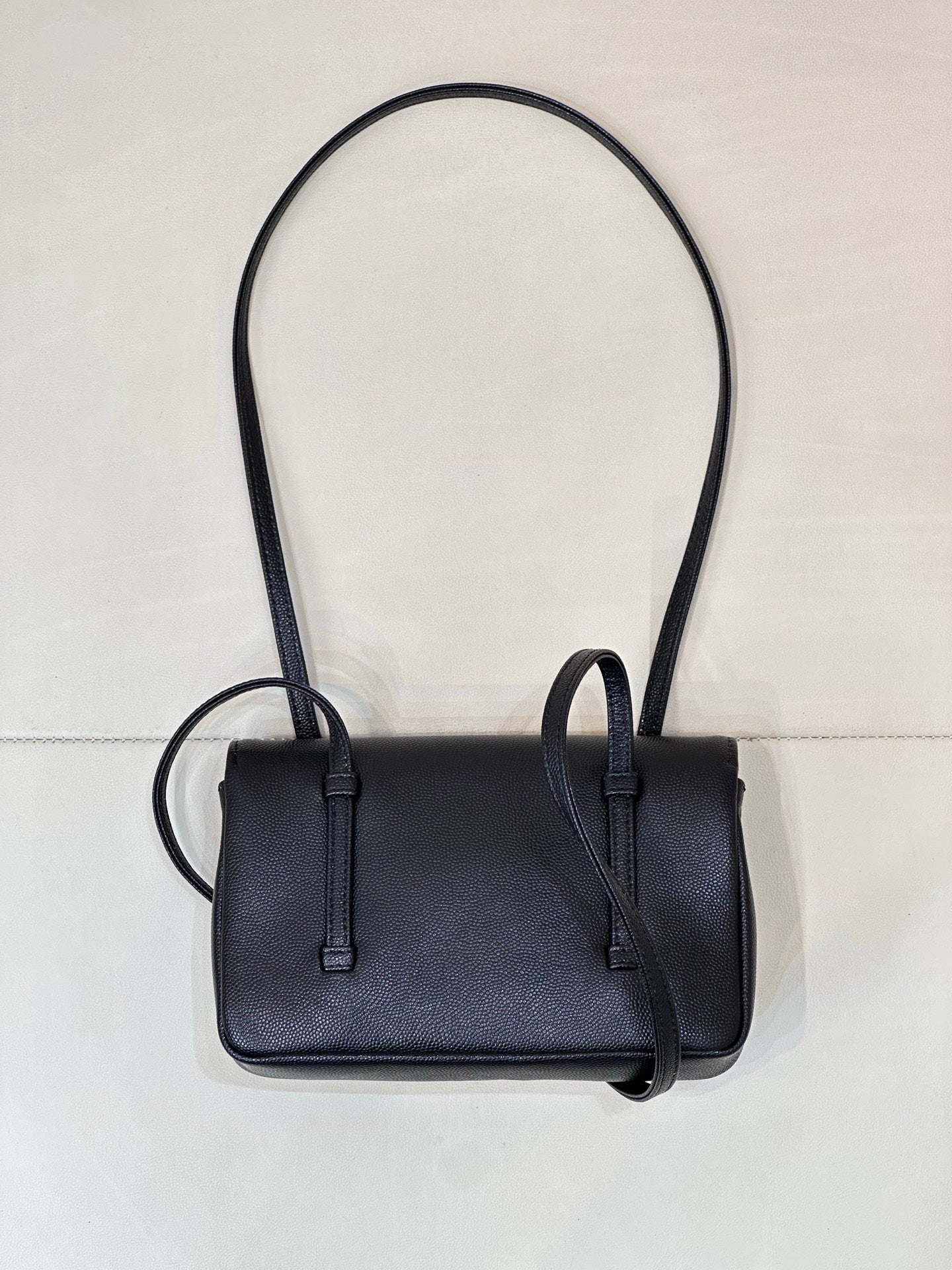 Chanel handbag front view with flap, dark blue leather, and two top handles.