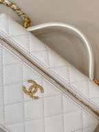 White quilted leather bag panel with gold zipper and gold logo detail.