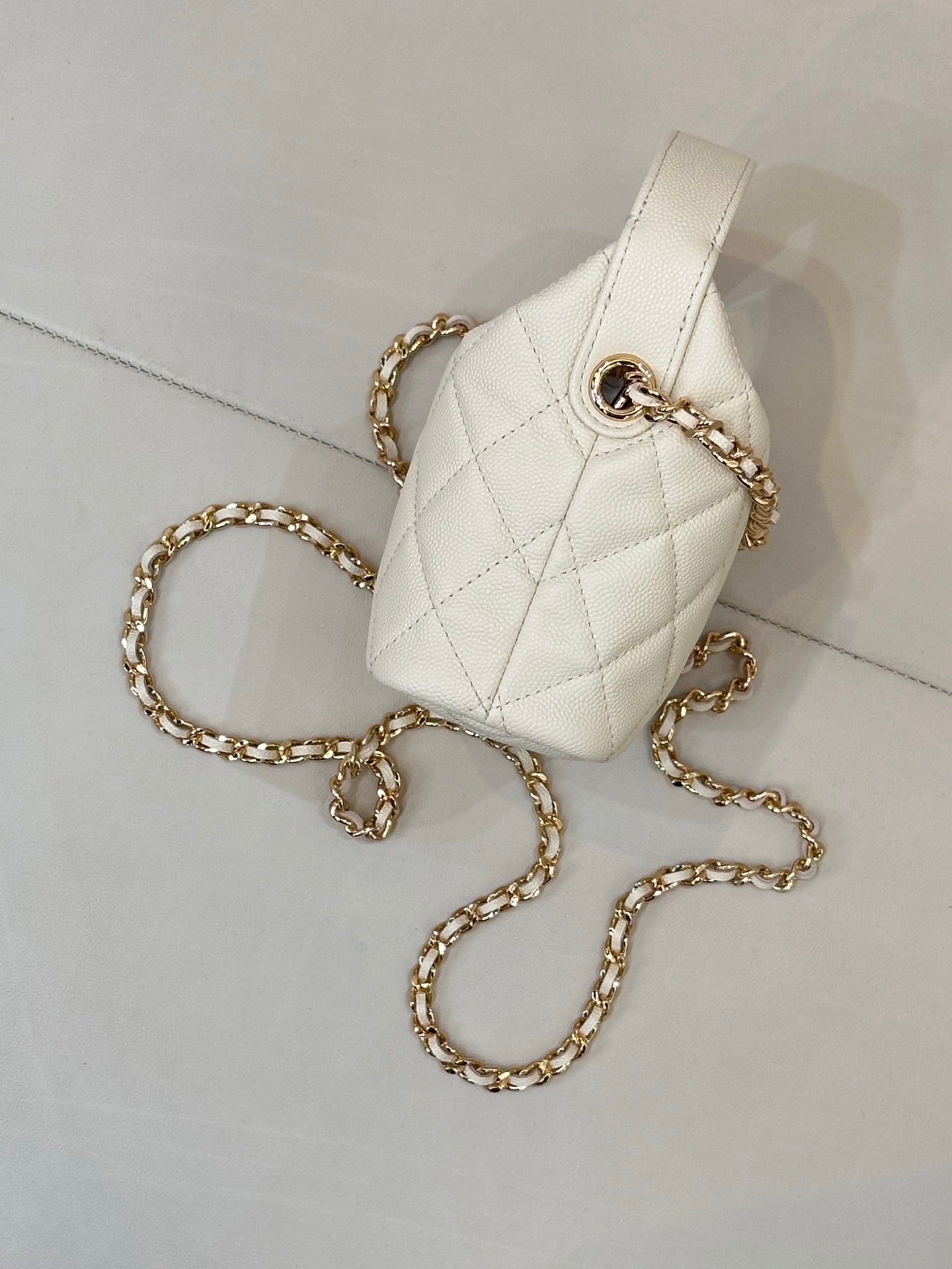 Chanel quilted mini bag, white, with gold chain strap and top handle ring