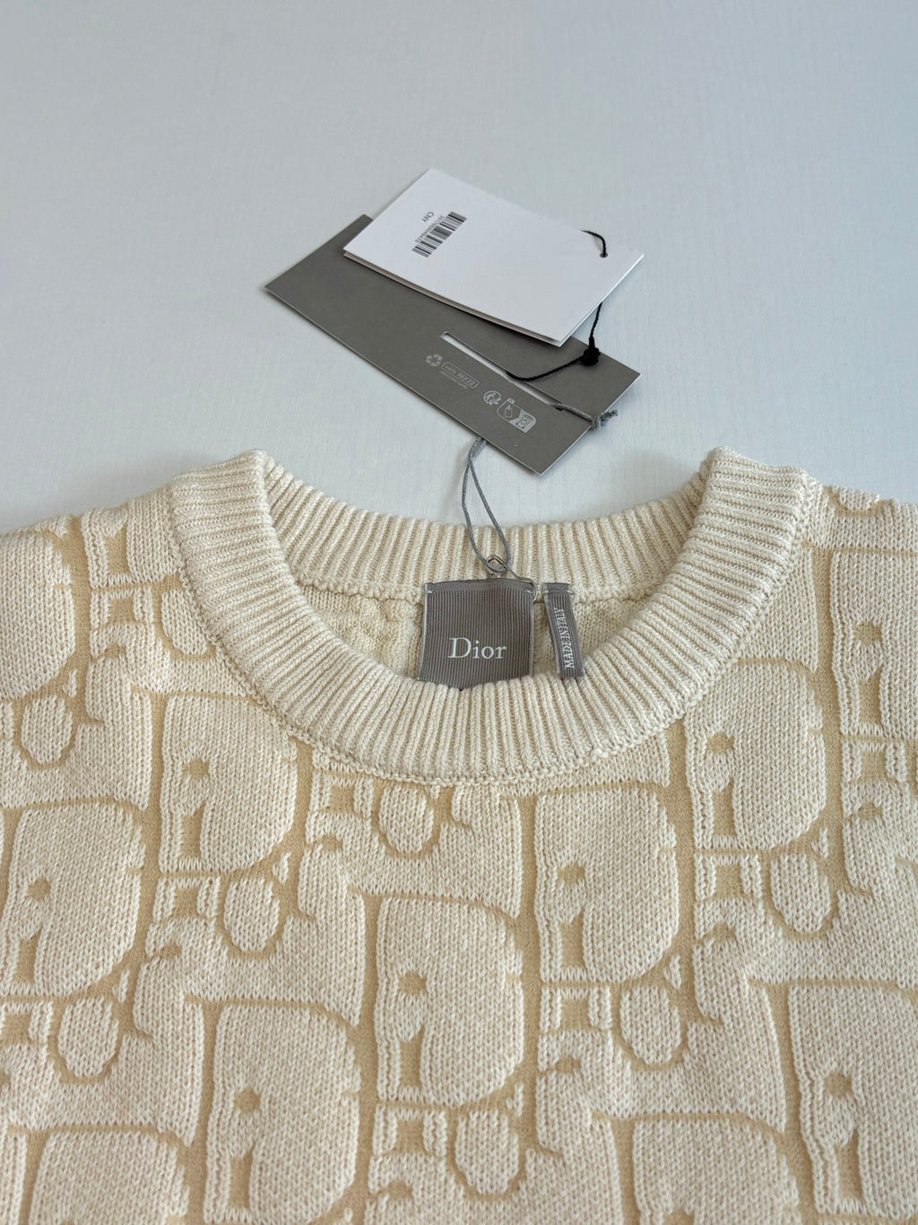 Cream jacquard knit sweater neckline with Dior label and ribbed crew collar
