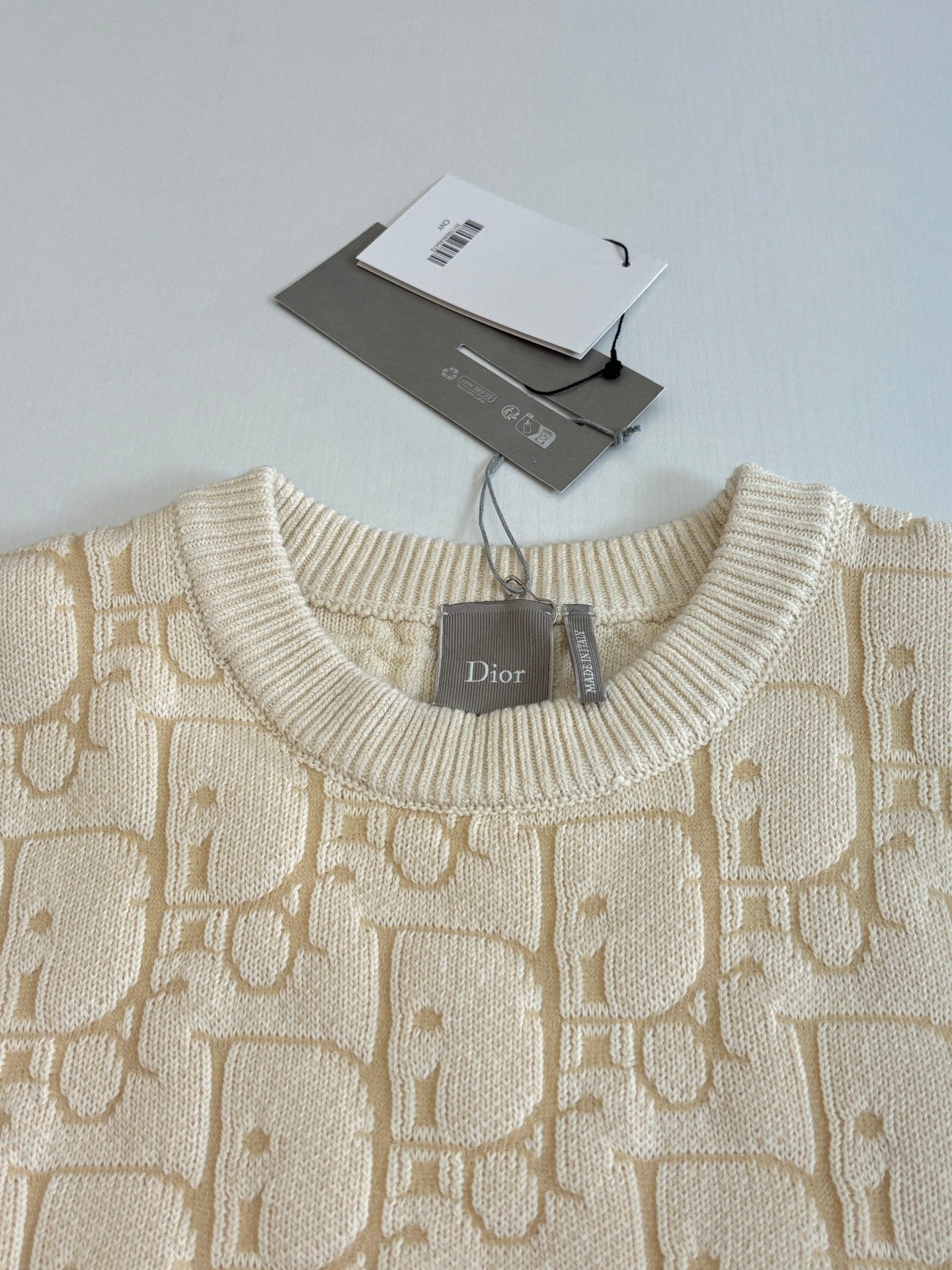 Cream jacquard knit sweater neckline with Dior label and ribbed crew collar
