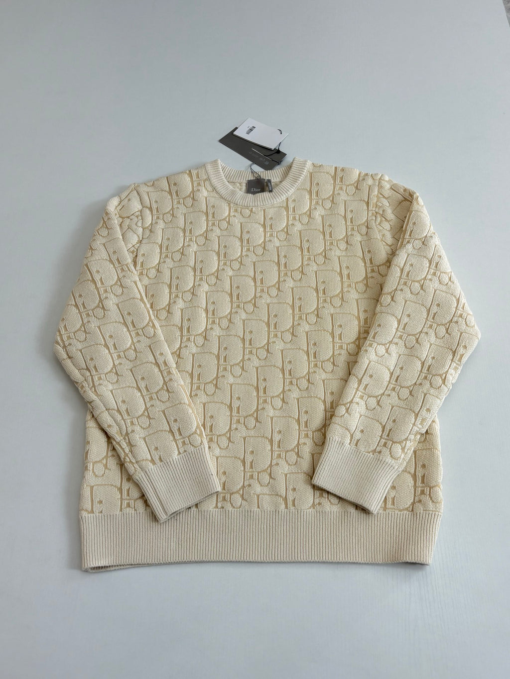 Cream jacquard knit sweater with crew neck and long sleeves, flat-lay view