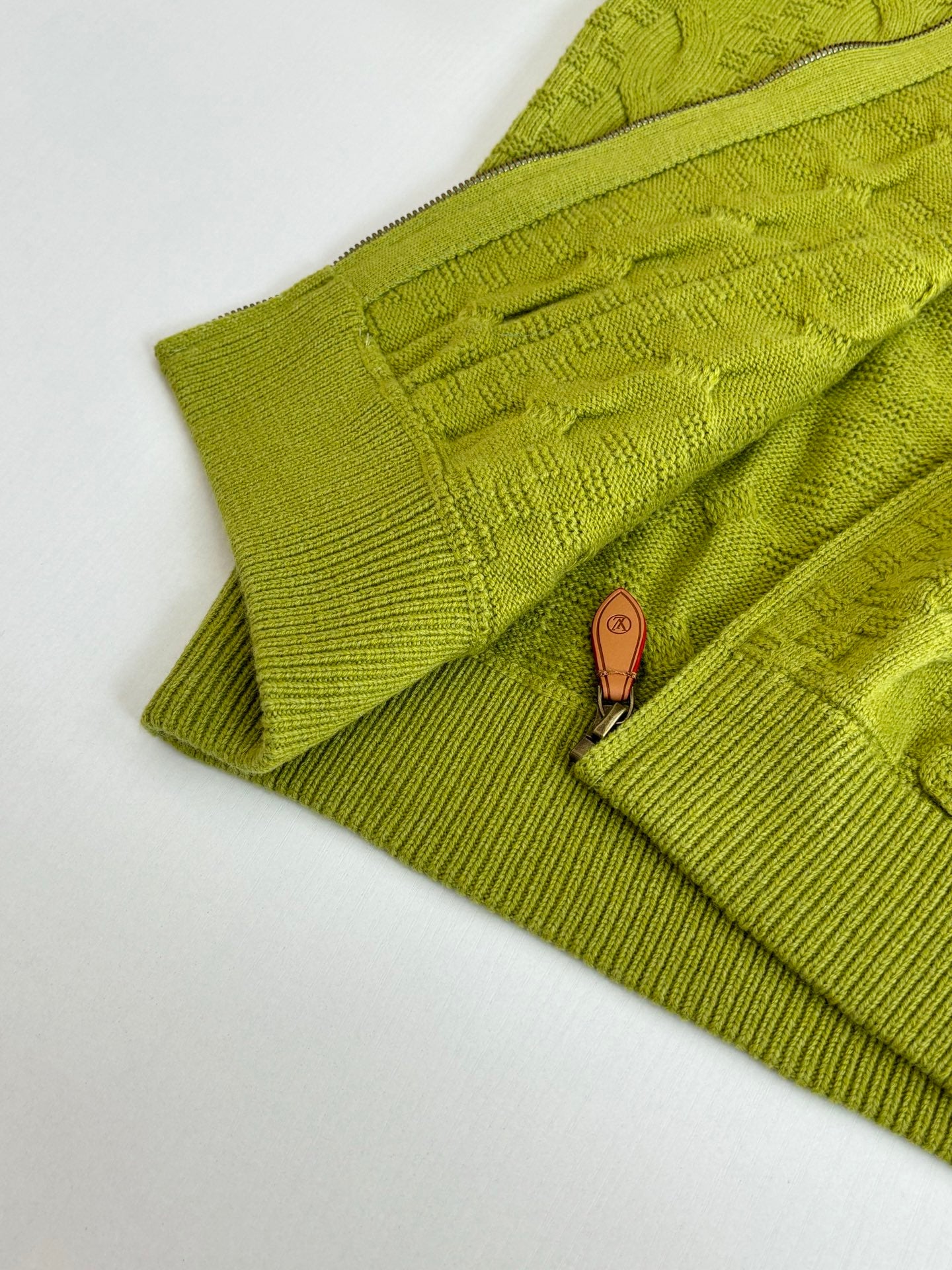 Lime green knit cardigan zipper with brown leather pull and textured knit