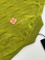 Green knit sweater fabric texture with Louis Vuitton square size label