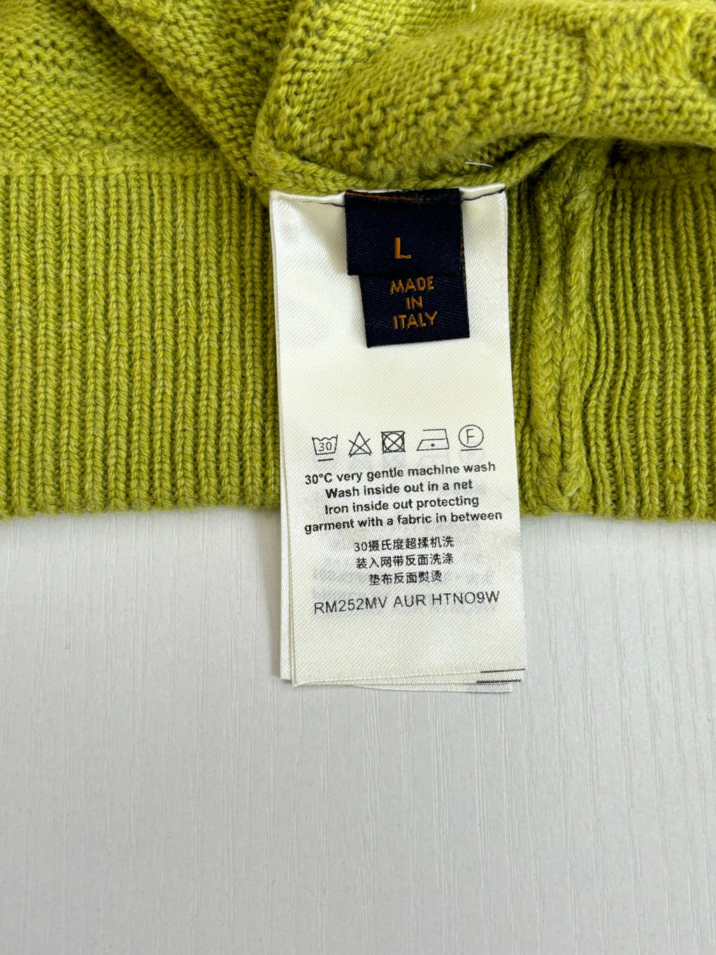 Lime green cardigan care label with size L and made in Italy