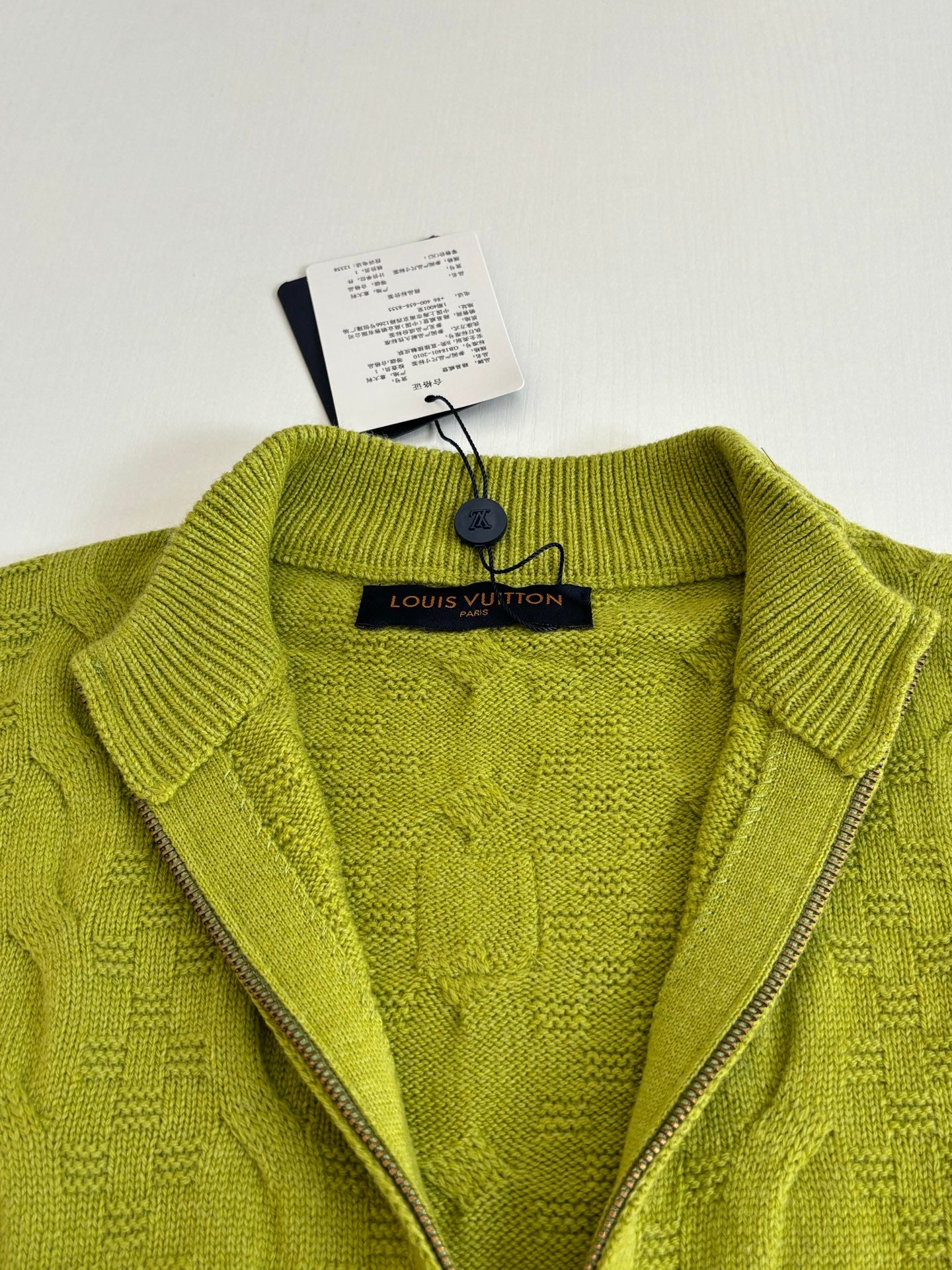 Lime green knit cardigan neckline with zipper and inner logo label