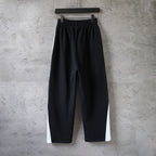 Black Balenciaga wide-leg pants with elastic waistband, no side logos visible