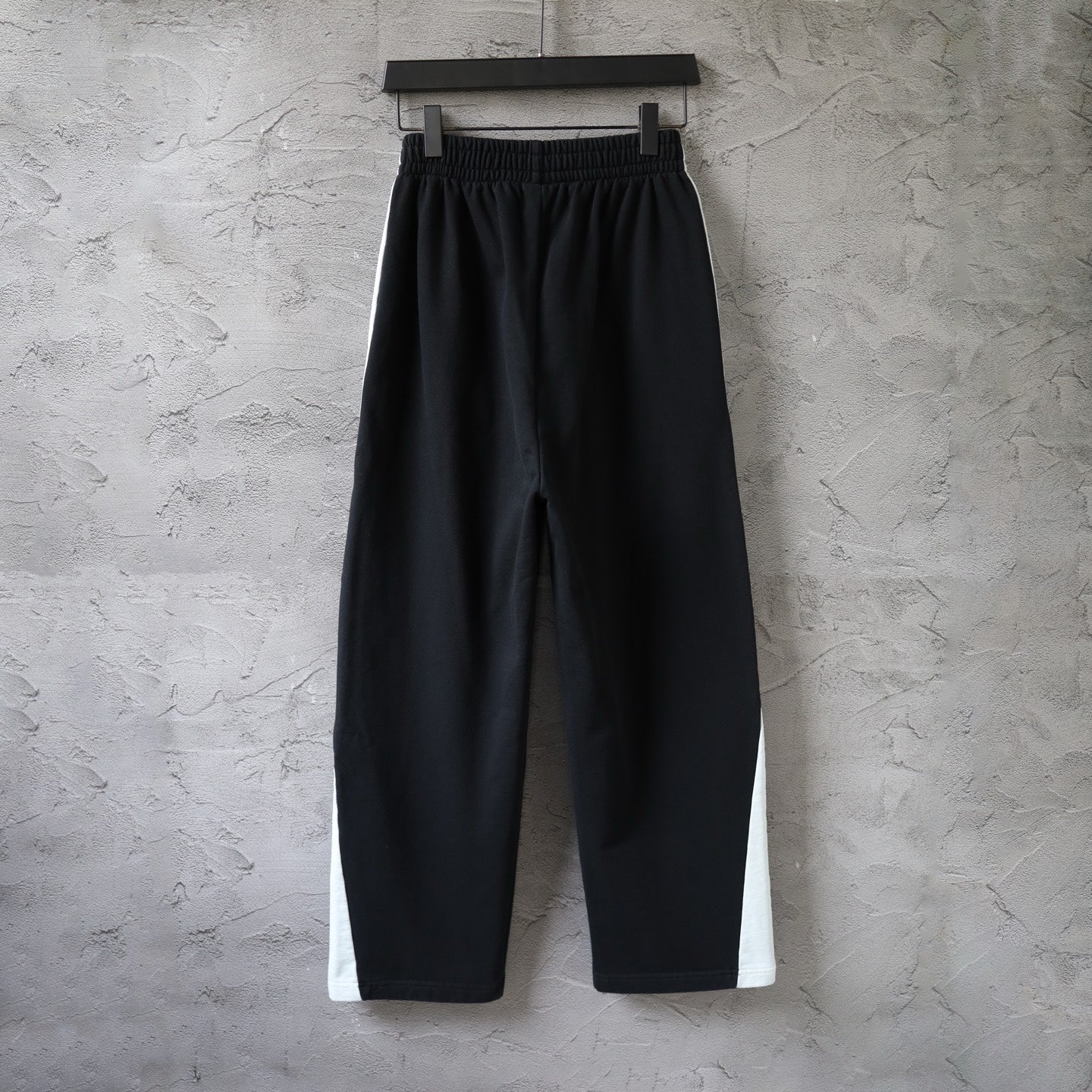 Black Balenciaga wide-leg pants with elastic waistband, no side logos visible