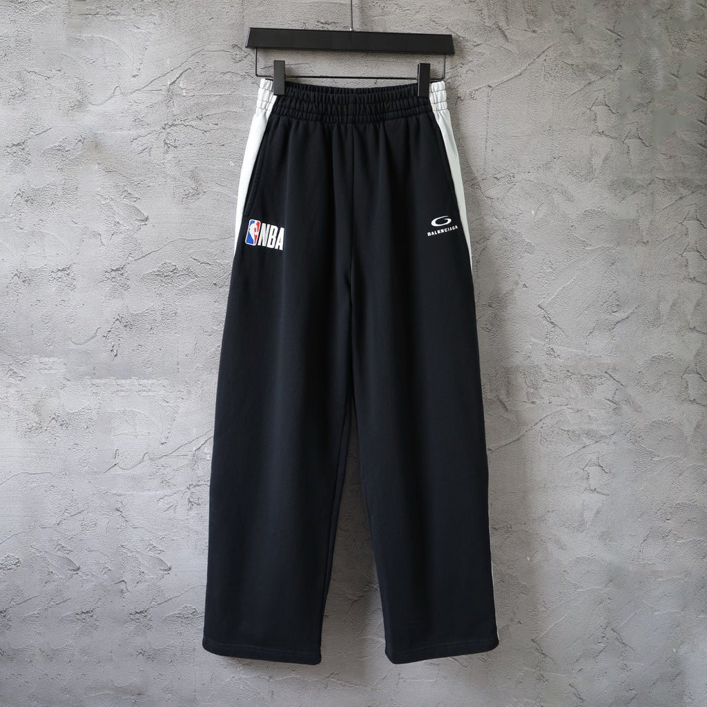Black Balenciaga wide-leg pants with elastic waistband and logo prints