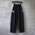 Black Balenciaga wide-leg pants with elastic waistband and logo prints