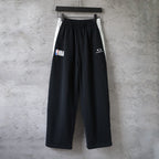 Black Balenciaga wide-leg pants with elastic waistband and logo prints
