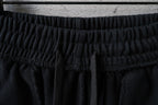 Black Balenciaga pants with gathered elastic waistband and back pleats