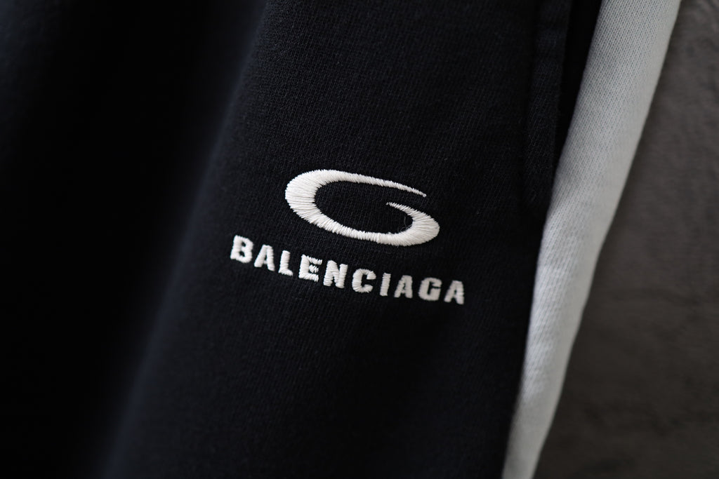 Black Balenciaga pants with white “BALENCIAGA” text and S logo