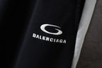 Black Balenciaga pants with white “BALENCIAGA” text and S logo