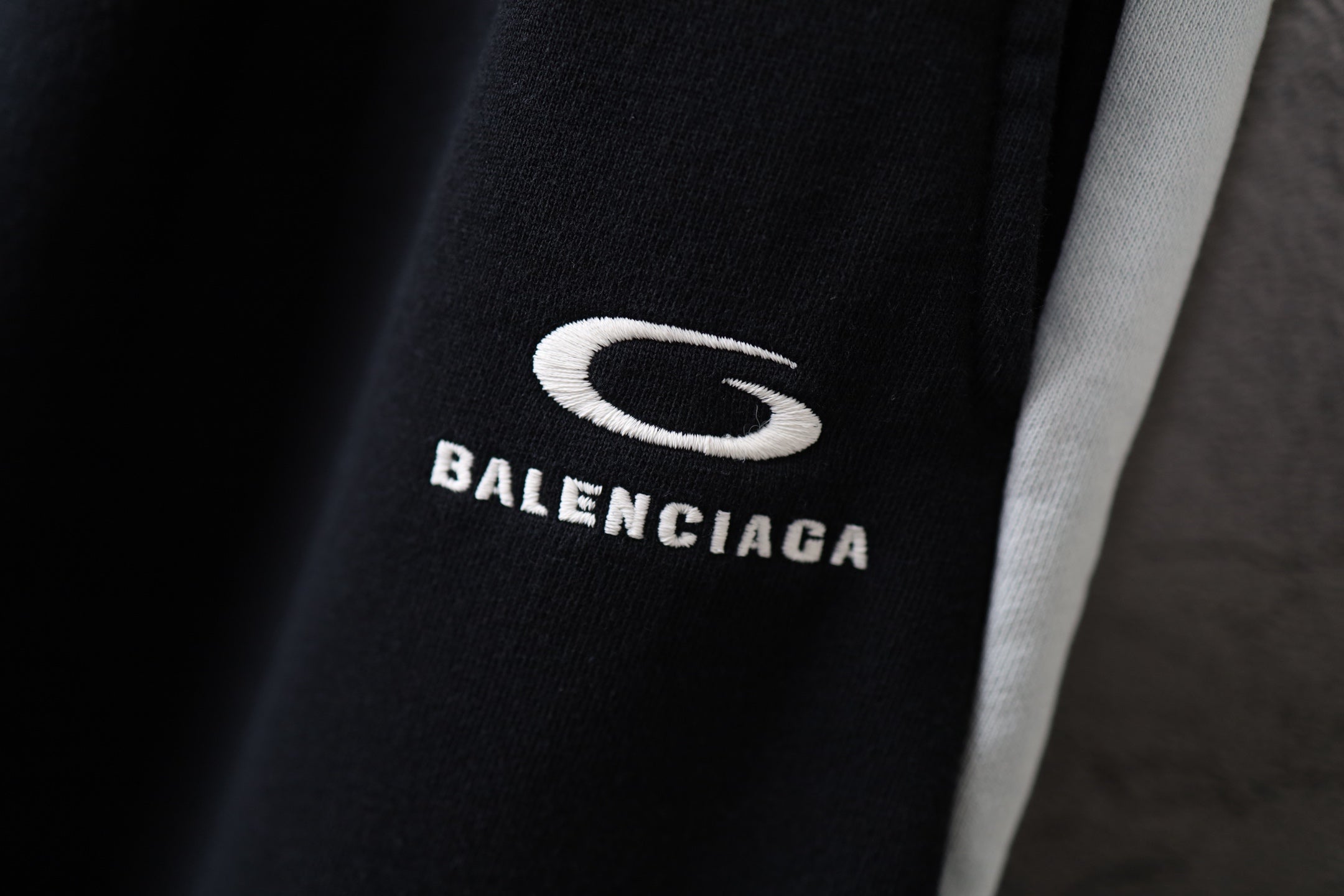 Black Balenciaga pants with white “BALENCIAGA” text and S logo