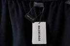 Black Balenciaga pants with brand hang tag at the waistband