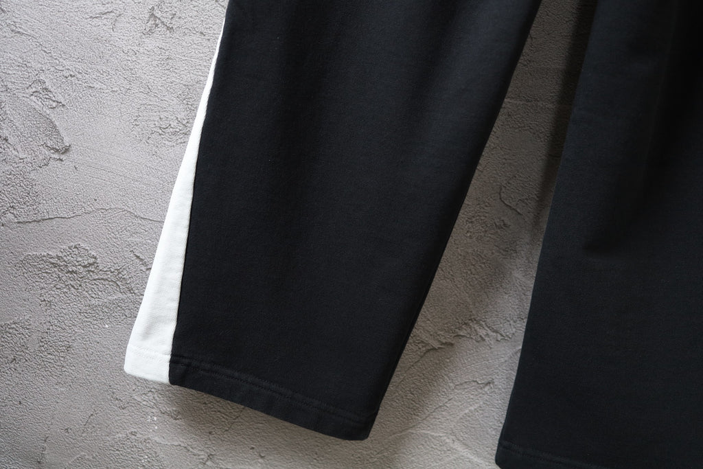 Black Balenciaga wide-leg pants with cuffed hem and side seam
