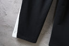 Black Balenciaga pants with wide straight legs and stitched hem