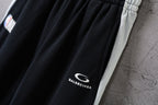 Black Balenciaga pants leg with small “BALENCIAGA” logo print