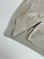 Beige cardigan sleeve and cuff with ribbed texture and angled folded view